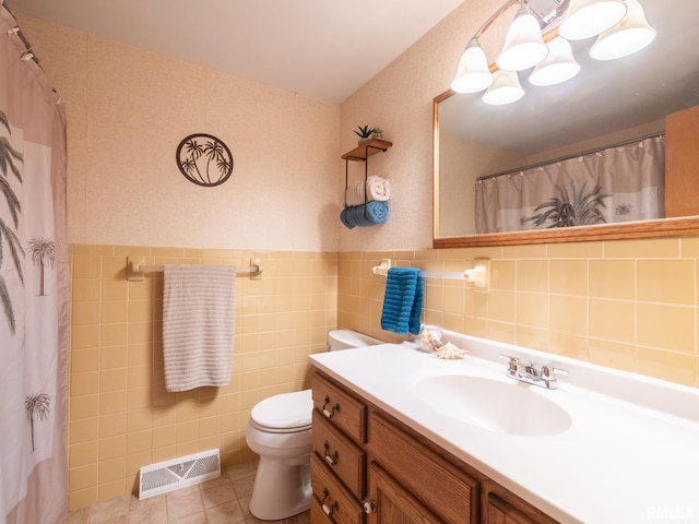 bathroom with tile patterned floors, vanity, and tile walls