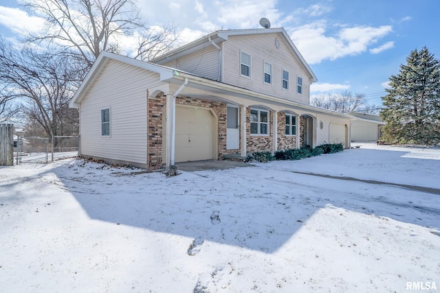 traditional home featuring a garage and fence