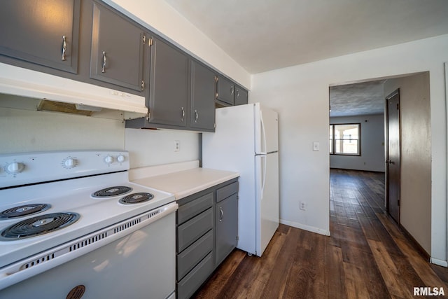 kitchen with white appliances, dark wood-type flooring, light countertops, gray cabinetry, and under cabinet range hood