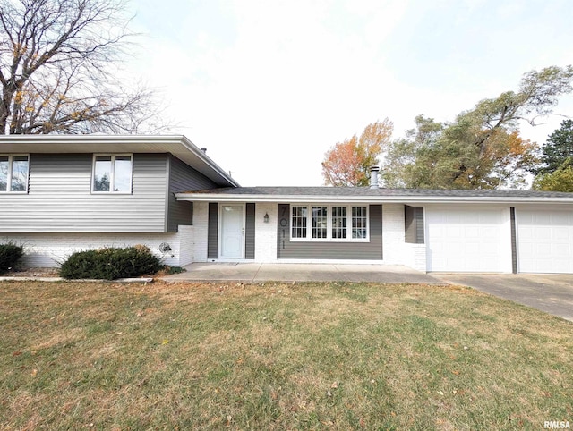 split level home with a garage and a front yard