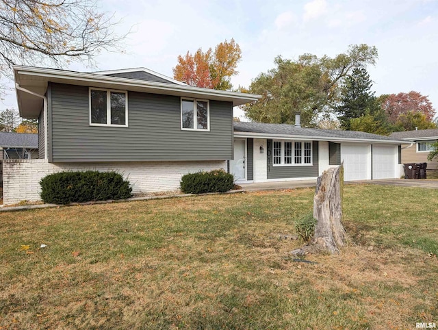 split level home with a garage and a front yard