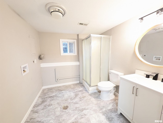 bathroom featuring a shower with shower door, vanity, and toilet