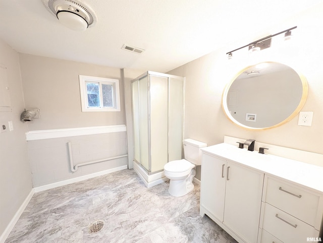 bathroom featuring toilet, an enclosed shower, and vanity