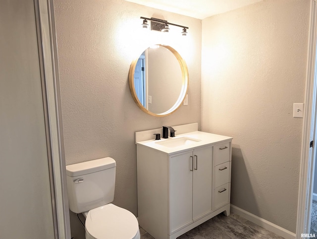 bathroom featuring toilet and vanity