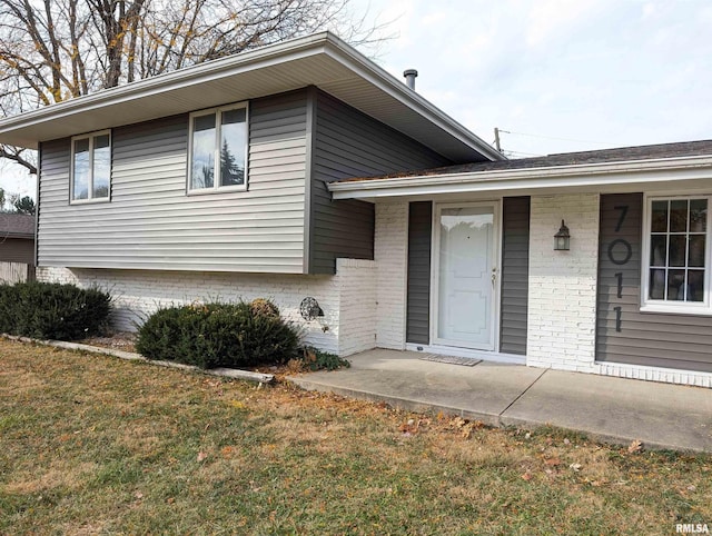 split level home featuring a garage and a front yard