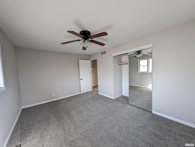 unfurnished bedroom featuring ceiling fan, a closet, and dark colored carpet