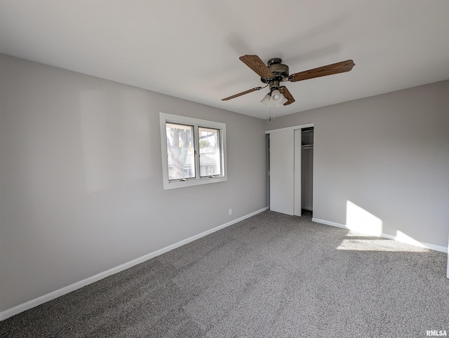 unfurnished bedroom with ceiling fan, a closet, and carpet flooring