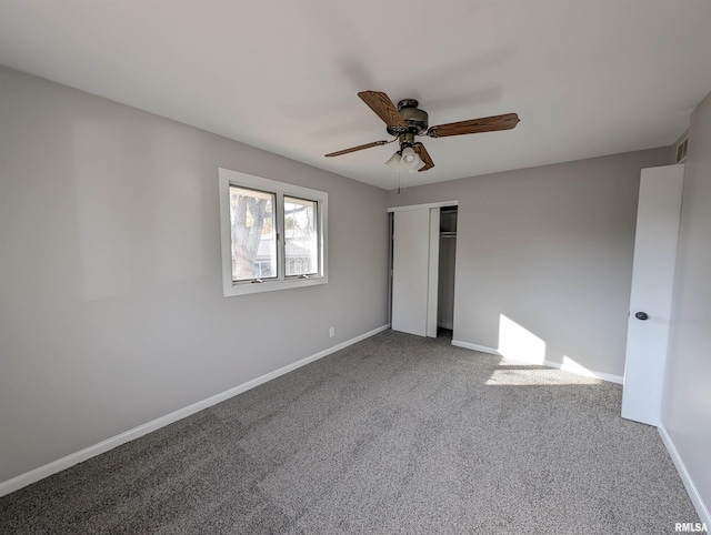 unfurnished bedroom with ceiling fan, carpet, and a closet