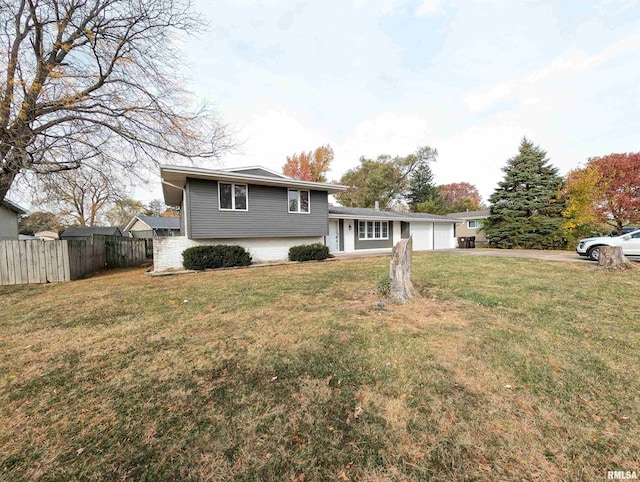 tri-level home with a garage and a front lawn