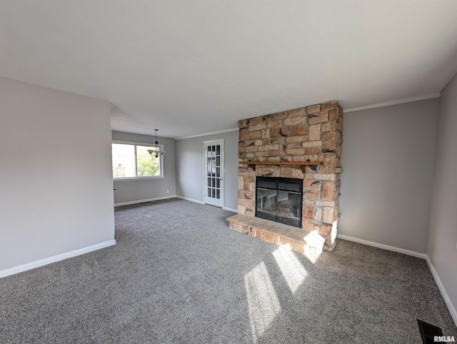 unfurnished living room featuring dark carpet, crown molding, and a stone fireplace