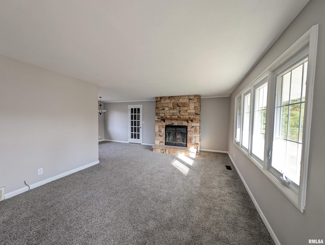 unfurnished living room with carpet and a stone fireplace