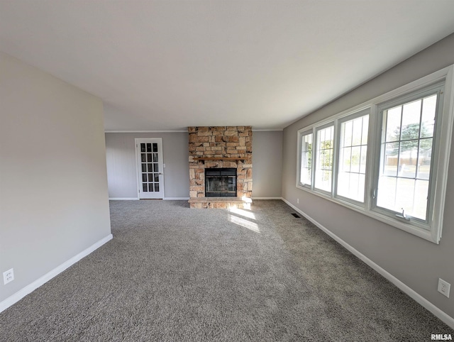 unfurnished living room featuring carpet flooring and a fireplace