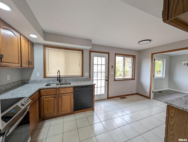 kitchen featuring light tile patterned floors, dishwasher, sink, and electric range