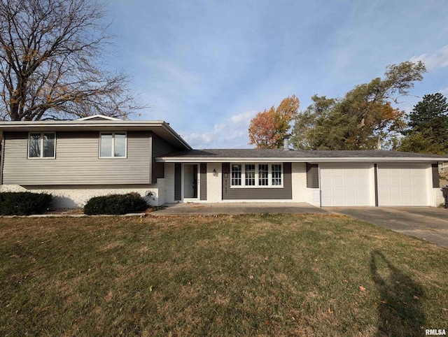 tri-level home with a front lawn and a garage