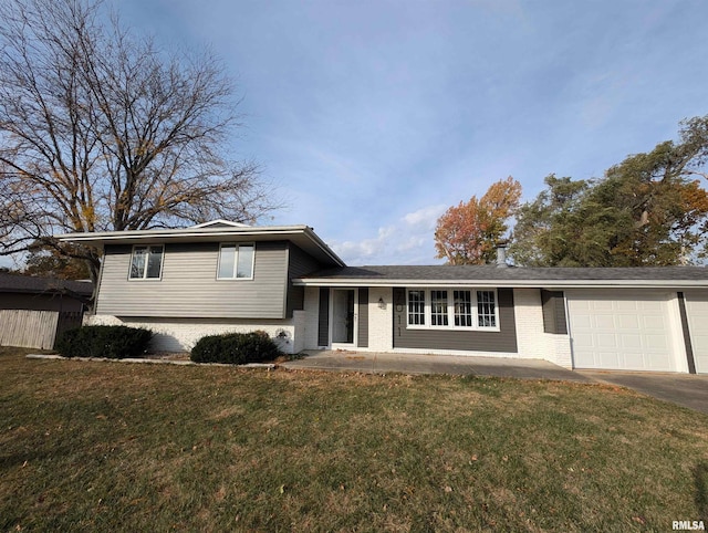 split level home featuring a front yard and a garage