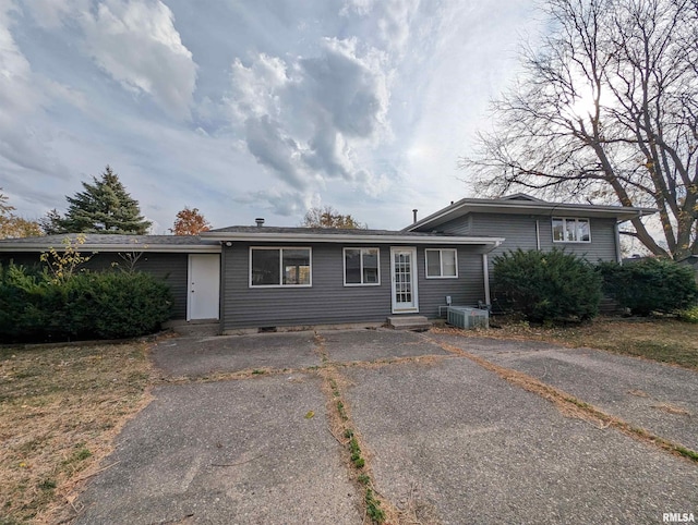 single story home featuring central air condition unit