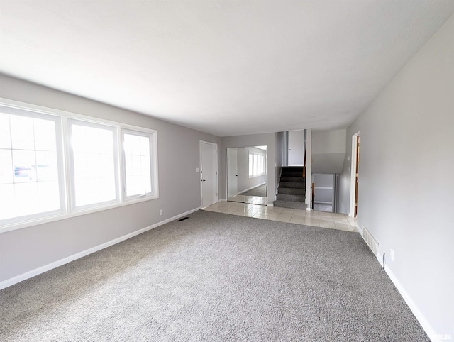 unfurnished living room featuring light carpet