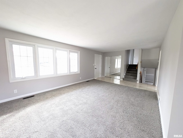 unfurnished living room with light carpet