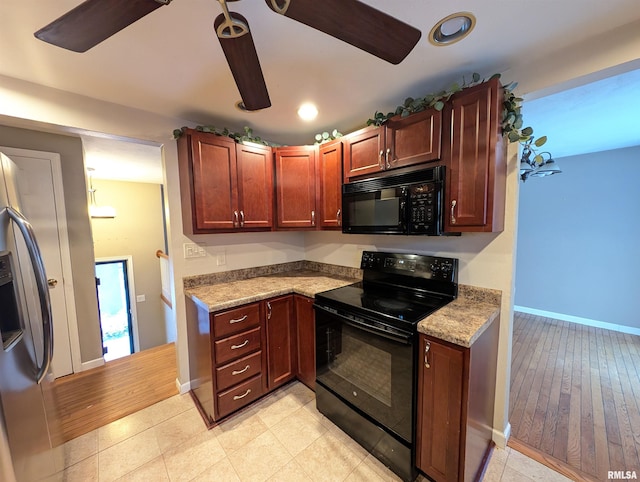 kitchen with black appliances and light stone countertops