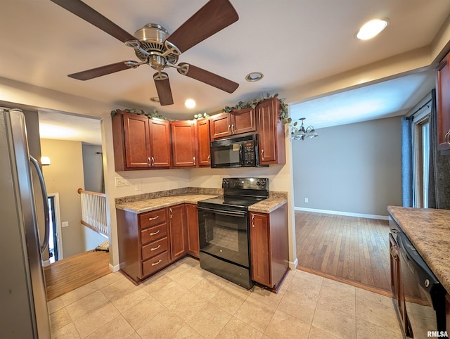 kitchen with black appliances, ceiling fan, and light hardwood / wood-style flooring