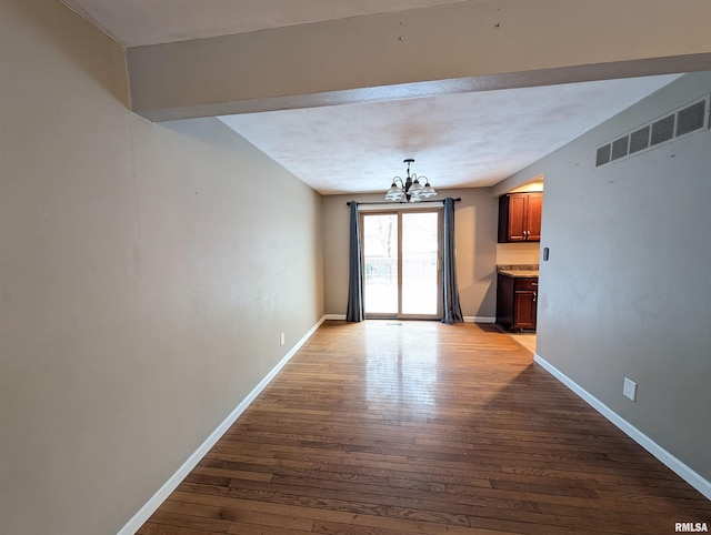 interior space featuring an inviting chandelier and light hardwood / wood-style flooring