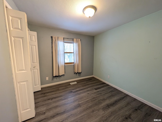 unfurnished room featuring dark hardwood / wood-style floors