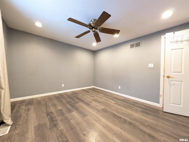 unfurnished room featuring ceiling fan and dark wood-type flooring