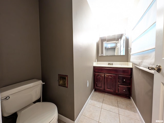 bathroom featuring toilet, vanity, and tile patterned floors