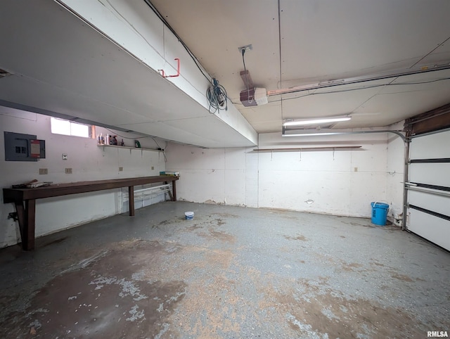 garage featuring a garage door opener and electric panel