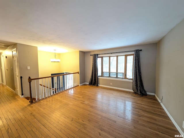 unfurnished room with light wood-type flooring