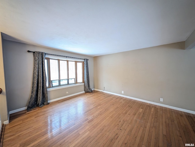 unfurnished room with light wood-type flooring