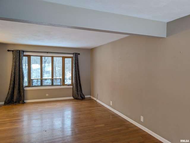 empty room with hardwood / wood-style floors