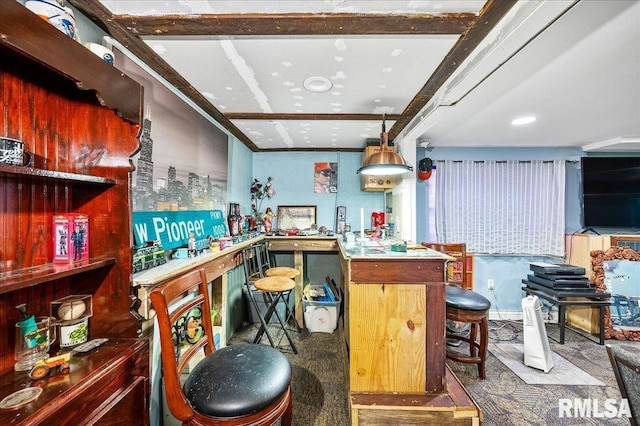 kitchen featuring carpet, decorative light fixtures, beam ceiling, and kitchen peninsula