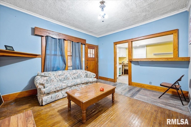 living room with wood-type flooring, a textured ceiling, and ornamental molding