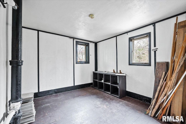 unfurnished room featuring a textured ceiling and dark hardwood / wood-style flooring