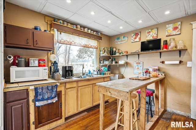 kitchen featuring tile counters, sink, and dark hardwood / wood-style floors