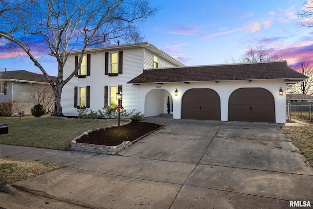 view of front of house featuring a yard and a garage