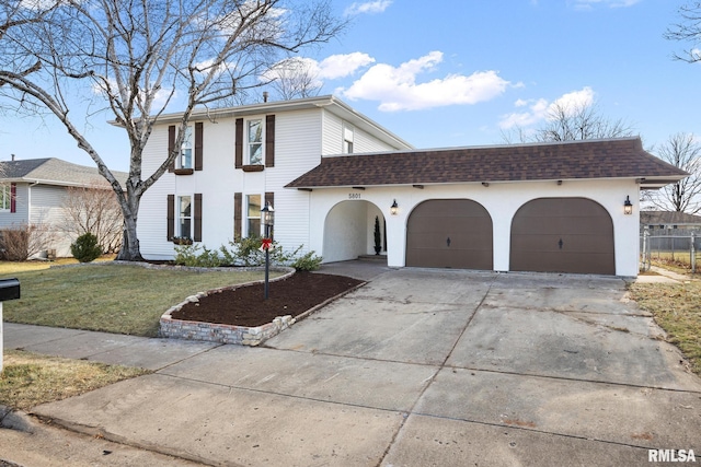 view of front of house with a garage and a front yard