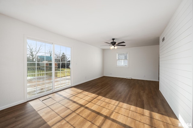 spare room with ceiling fan and dark wood-type flooring