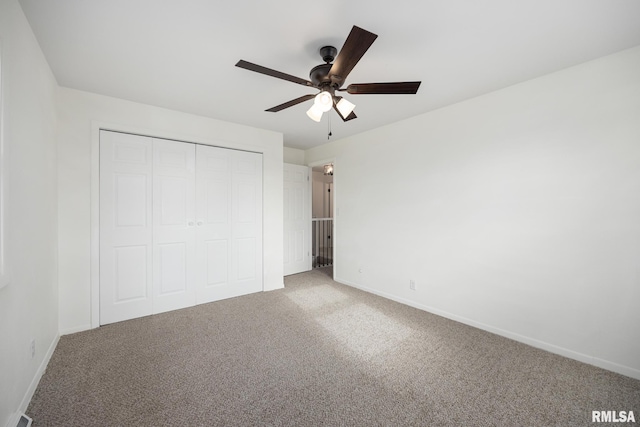 unfurnished bedroom with carpet flooring, ceiling fan, and a closet