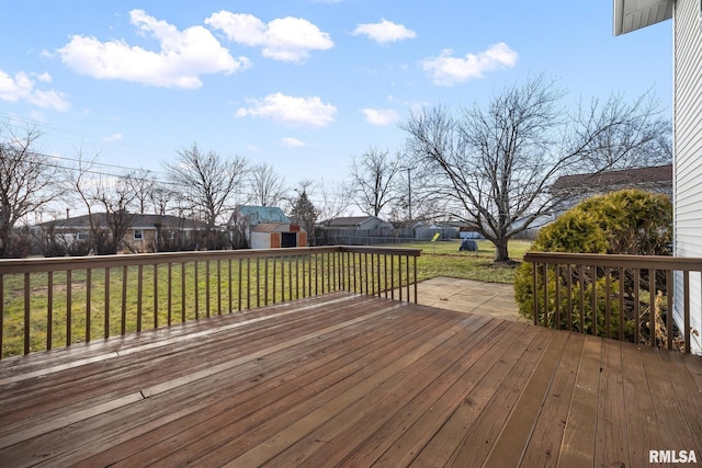 wooden terrace with a shed and a yard