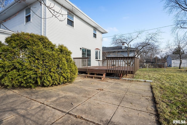 rear view of house with a yard, a patio, and a wooden deck