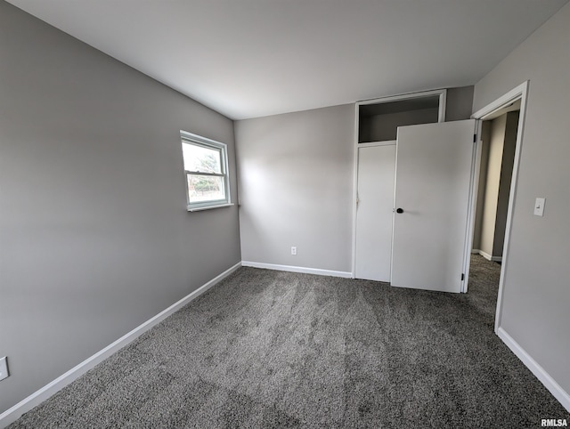 unfurnished bedroom featuring carpet and baseboards