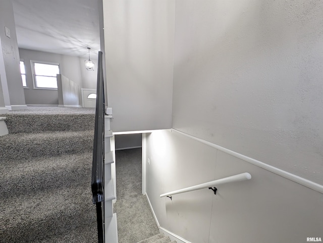 stairs featuring carpet flooring and baseboards