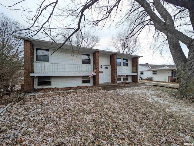 raised ranch featuring brick siding