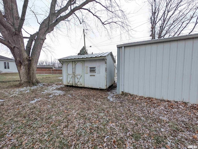 view of shed featuring fence