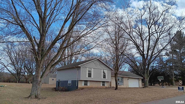 view of front of property featuring an attached garage and brick siding