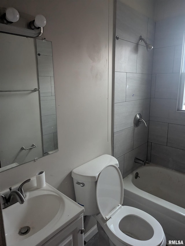 full bathroom featuring vanity, tiled shower / bath combo, and toilet