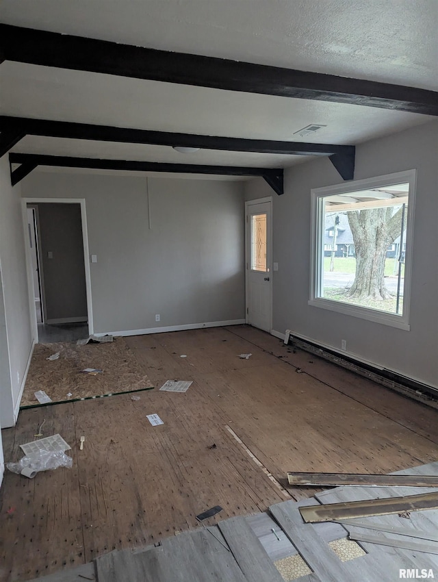 unfurnished living room featuring vaulted ceiling with beams and a baseboard heating unit