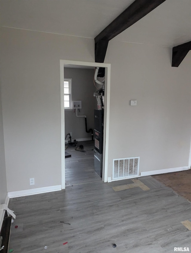 interior space featuring beam ceiling and hardwood / wood-style flooring